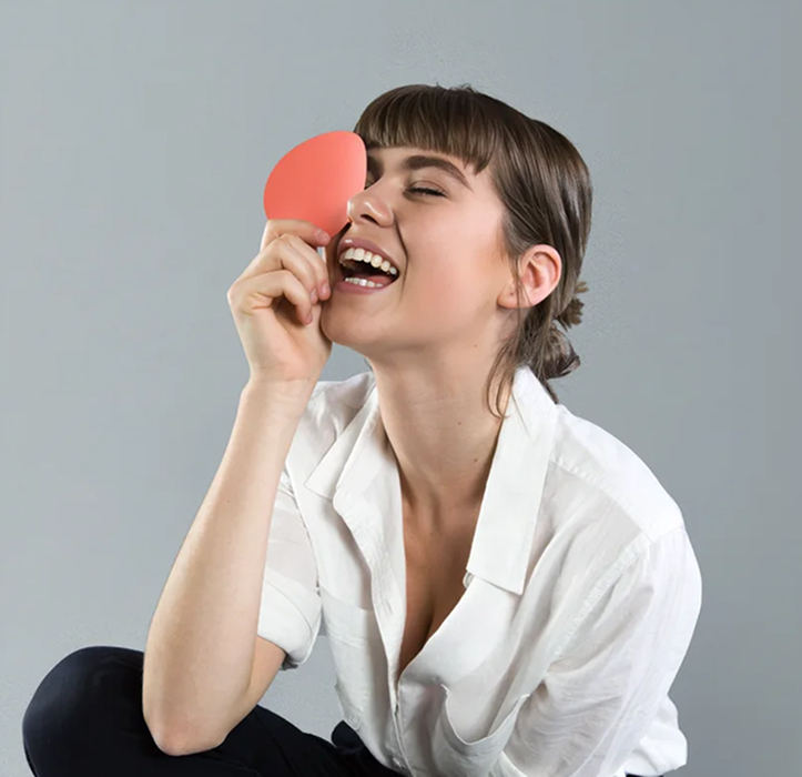 Design student holding a coral colour swatch, Certificate III in Design Fundamentals